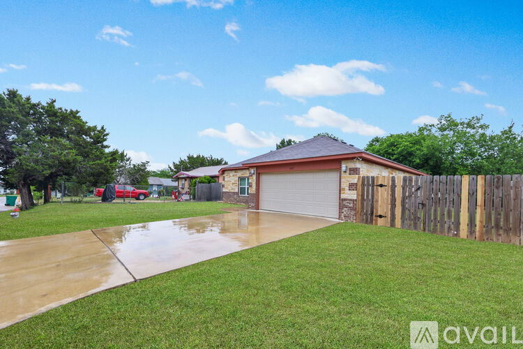 A house with a garage and a driveway in front of it.