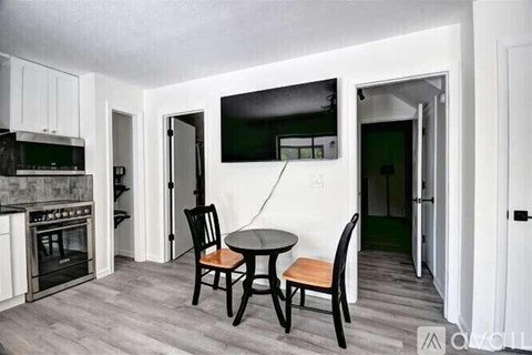 A kitchen with a table and chairs in the middle of the room.