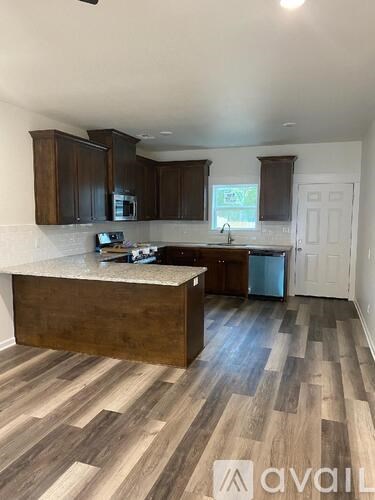 A kitchen with wooden cabinets and a countertop.