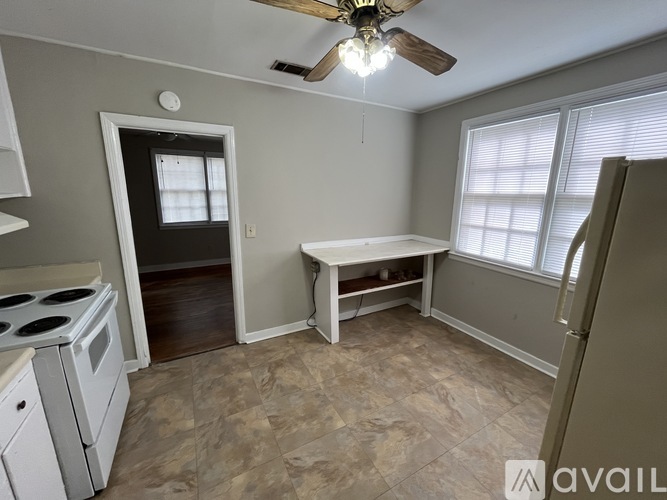 A kitchen with a stove top oven and a table.