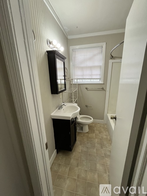 A bathroom with a sink, toilet, and shower.