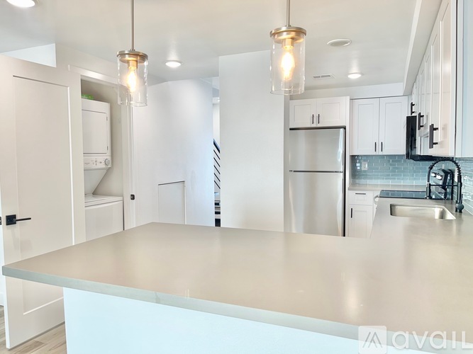 A modern kitchen with a large island in the center.
