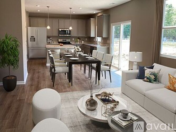 A modern living room with a dining table and chairs.