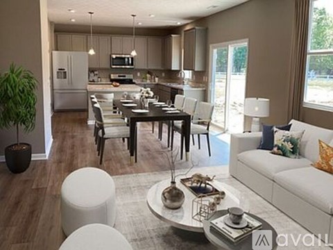 A modern living room with a dining table and chairs.