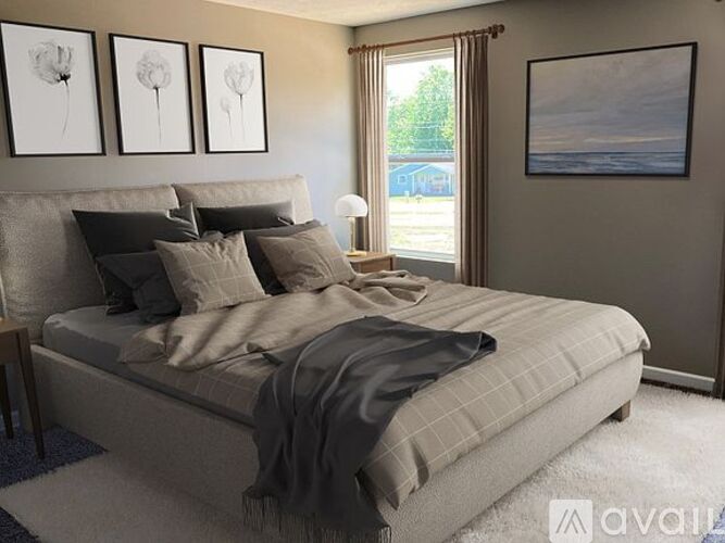 A bedroom with a large bed and a window.