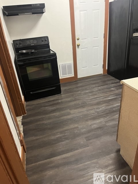 A kitchen with a black oven and a black refrigerator.