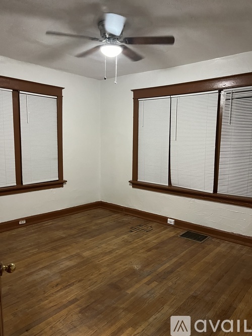 A room with wooden floors and a ceiling fan.