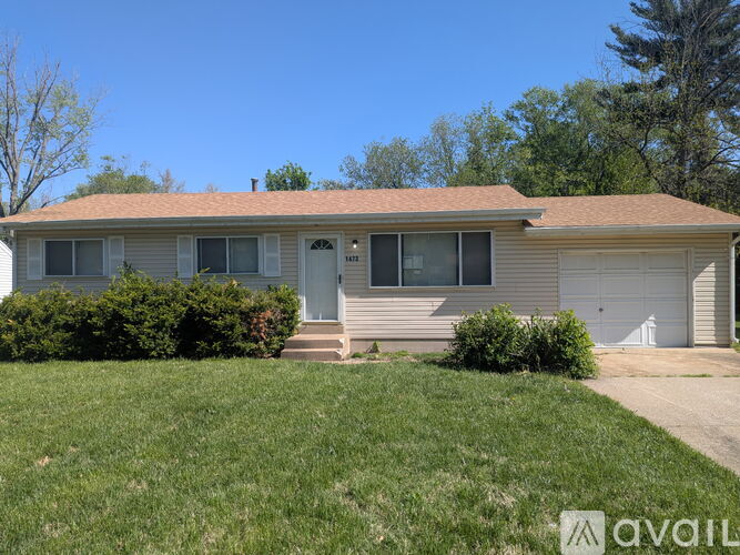 A house with a lawn in front and a sign that says "available".