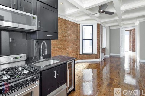 A kitchen with a stove top oven and a microwave.