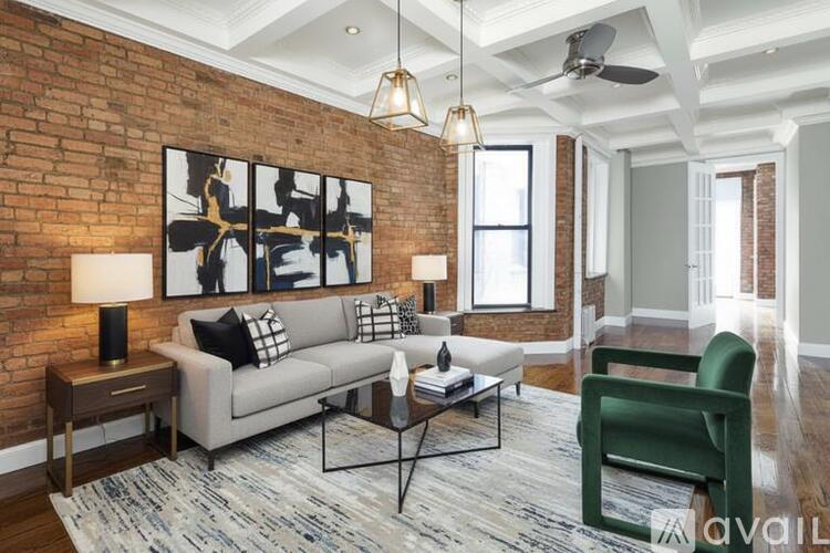 A living room with a grey couch, a green chair, and a coffee table.