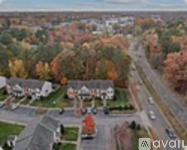 A suburban neighborhood with houses and trees in autumn colors.