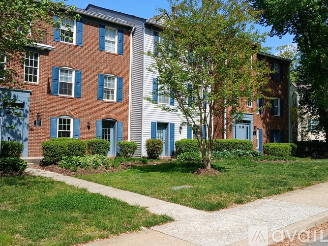 A red brick building with white trim and blue shutters.
