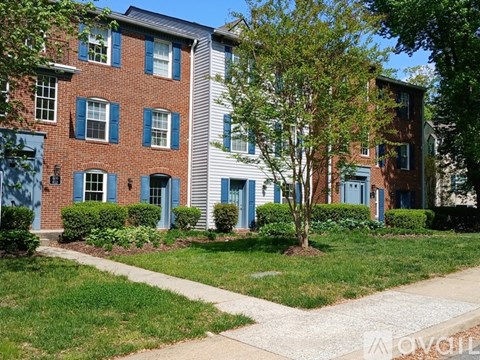A red brick building with white trim and blue shutters.