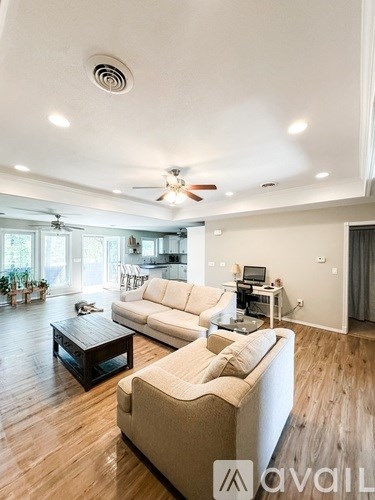 A living room with a white couch and a coffee table.