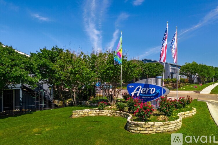 Aero sign in front of a building with flags.