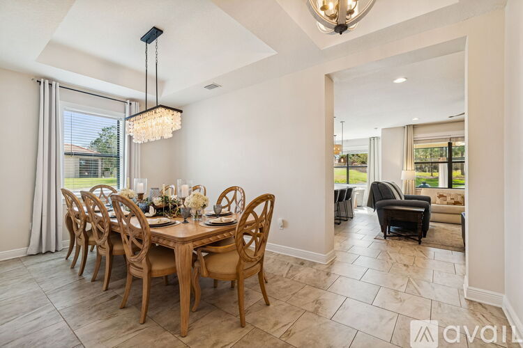 A dining room with a wooden table set for a meal.
