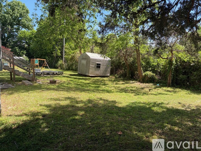 A backyard with a shed and a playground.