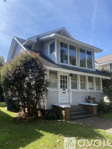 A house with a white door and a grey roof.