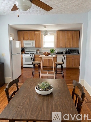 A kitchen with wooden cabinets and a white refrigerator.