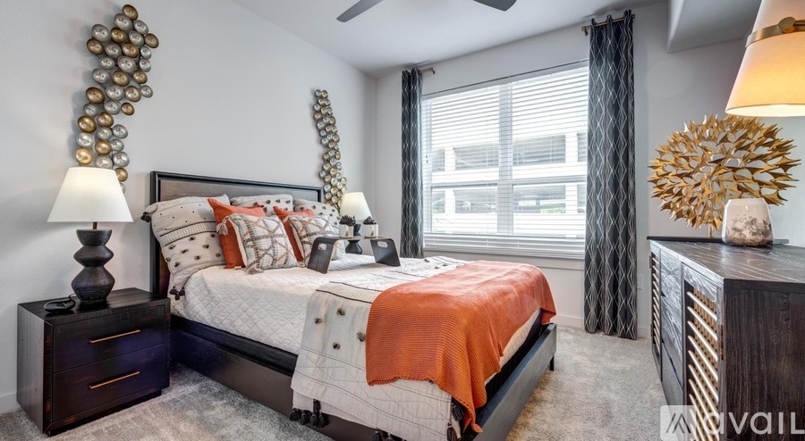 A bedroom with a large bed and a ceiling fan.