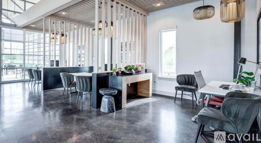 A modern dining room with a long table and chairs.