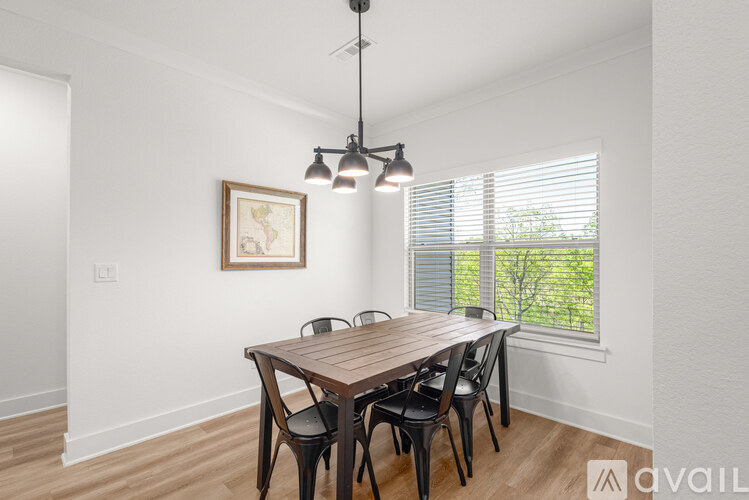 A dining room with a wooden table and chairs.