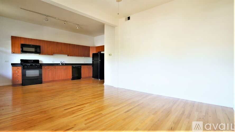 A kitchen with black appliances and wooden cabinets.