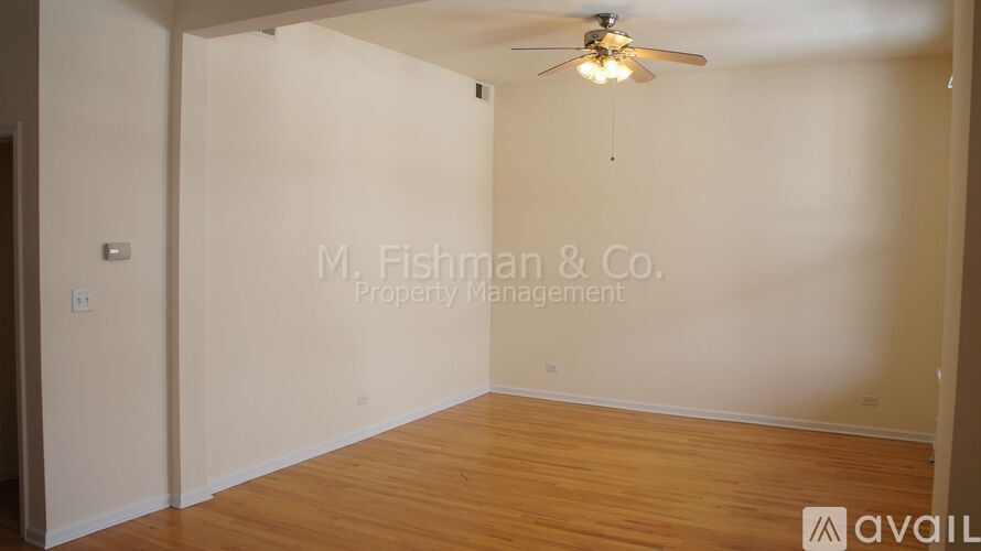 A room with a ceiling fan and wooden flooring is available for rent.