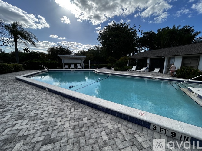 A pool with a depth of 3 feet 9 inches is surrounded by a brick patio.