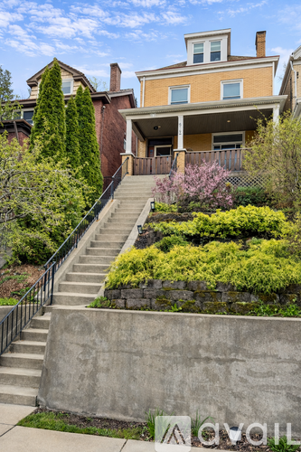 A house with a staircase leading to the front door.