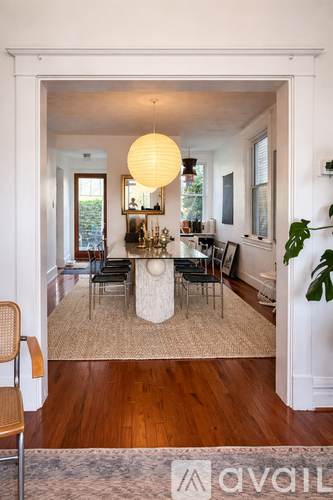 A living room with a white table and chairs.