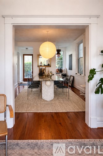 A living room with a white table and chairs.