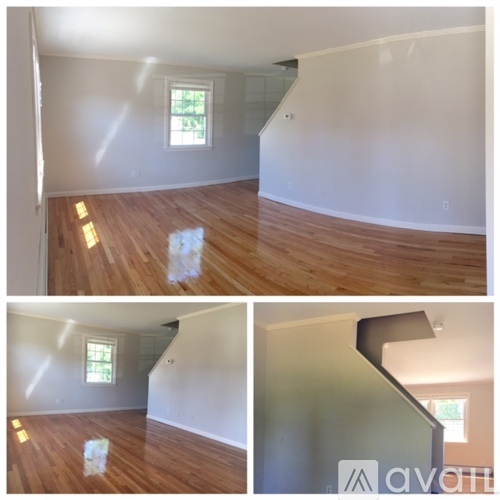 A room with wooden floors and a window.