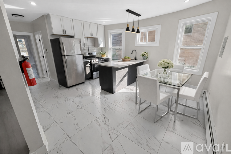 A modern kitchen with a glass table and white chairs.