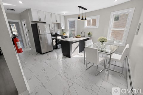 A modern kitchen with a glass table and white chairs.