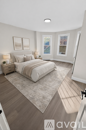 A bedroom with a large bed and a window with a view of a cityscape.