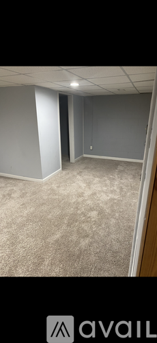 A room with a carpeted floor and a white wall.