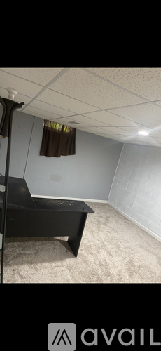 A room with a black bench and a carpet.