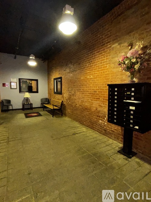 A room with a brick wall and a bench.