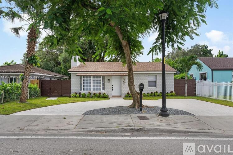 A house with a tree in front of it.
