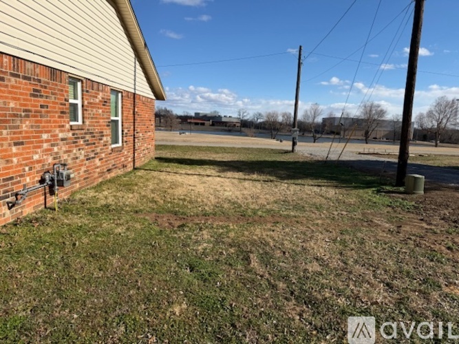 A house with a brick exterior and a grassy yard.