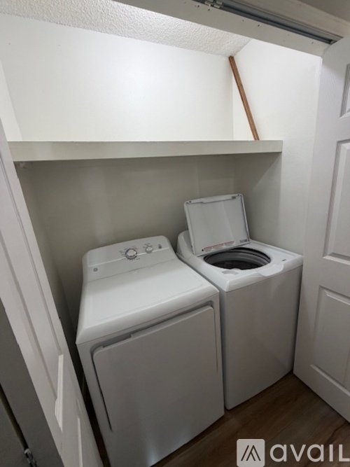 A small laundry room with a washer and dryer.