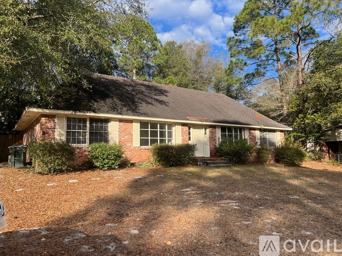 A house with a brown roof and a sign that says "available" in front of it.