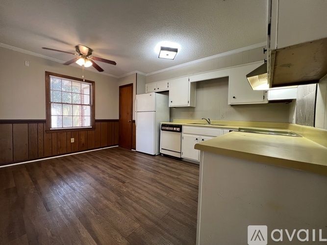 A kitchen with a refrigerator, stove, and oven.