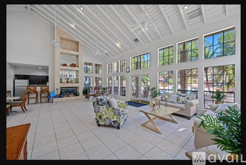 A spacious living room with a fireplace and large windows.