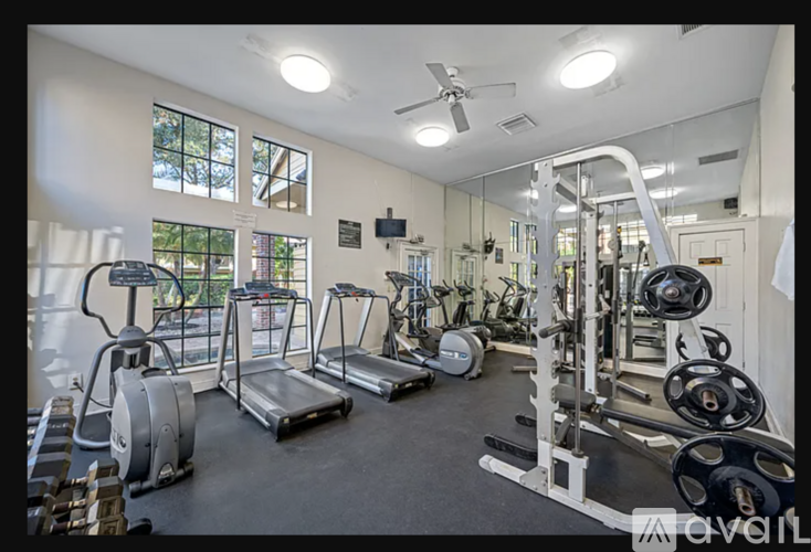 A well-equipped gym with various exercise machines and weights.