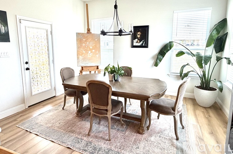 A dining room with a table and chairs.