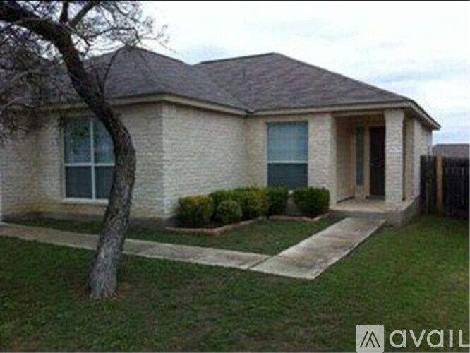 A house with a tree in front of it.
