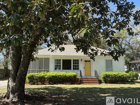 A house with a yellow door is for sale.