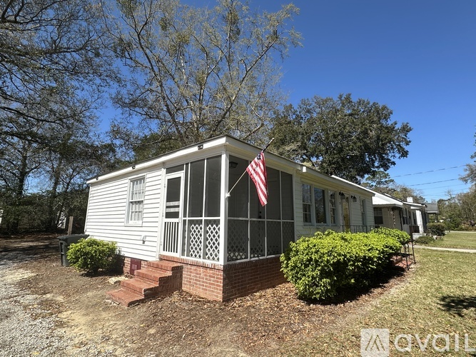 A small house with a flag on the front porch.